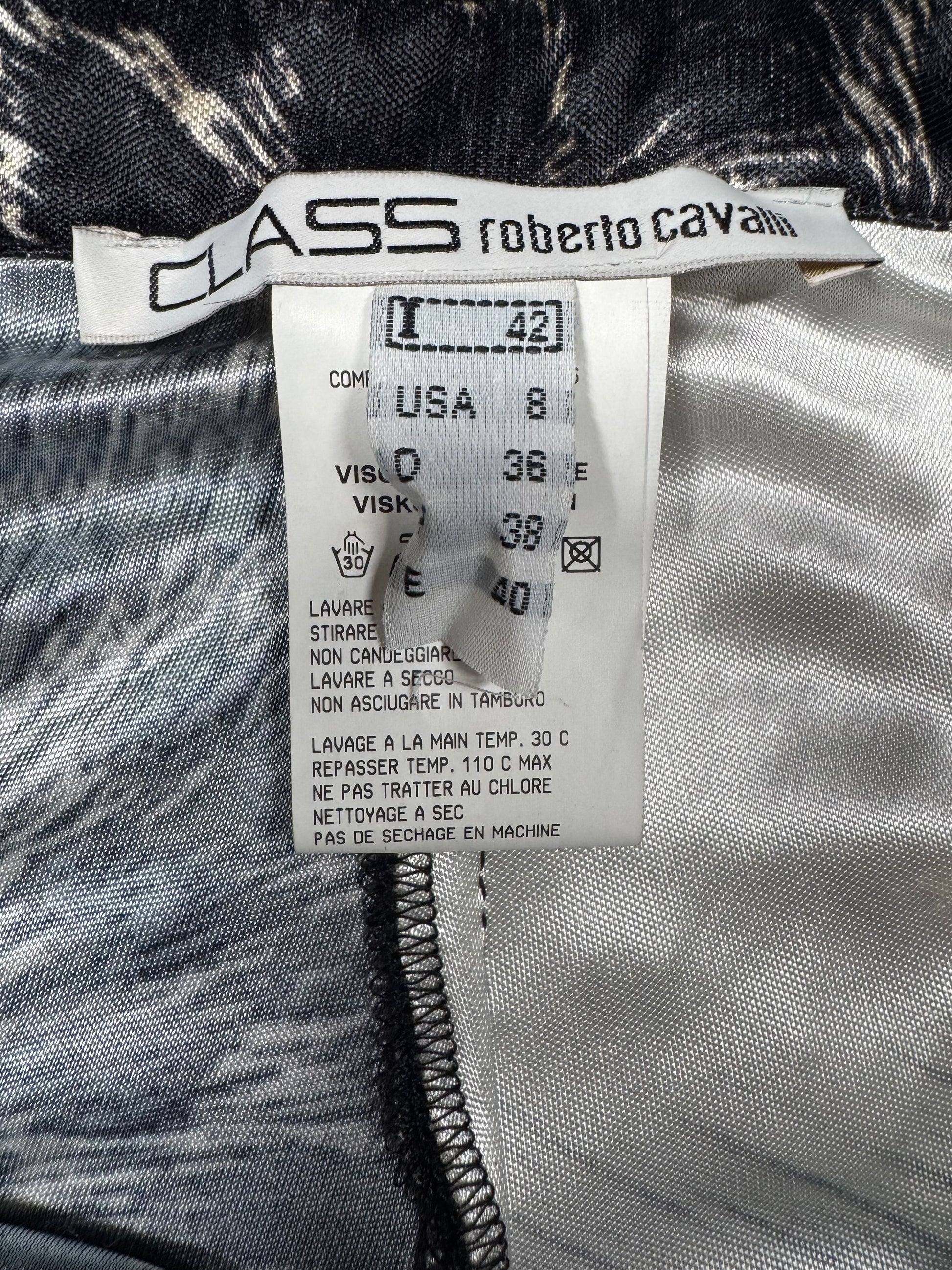 Clothing tag with 'Class Roberto Cavalli' branding on a textured fabric background