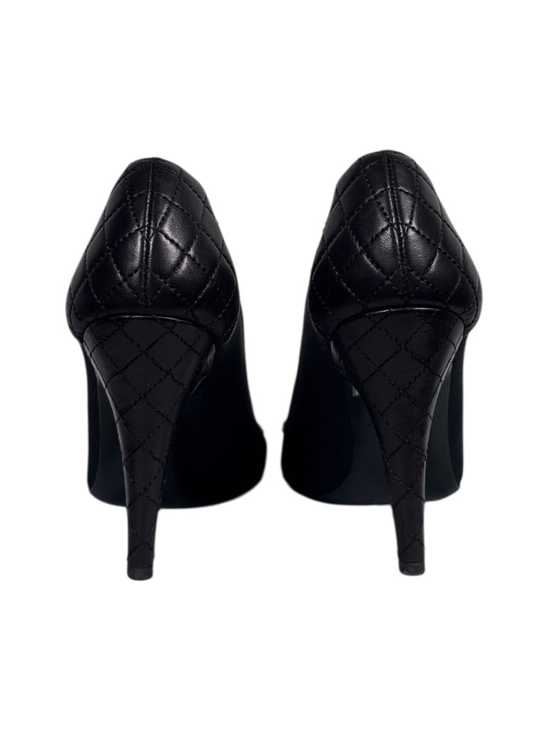 Pair of black high-heeled shoes on a white background