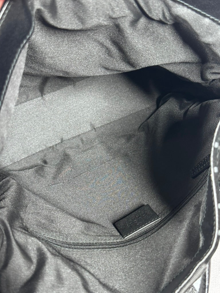 Gray bag interior with a visible brand label