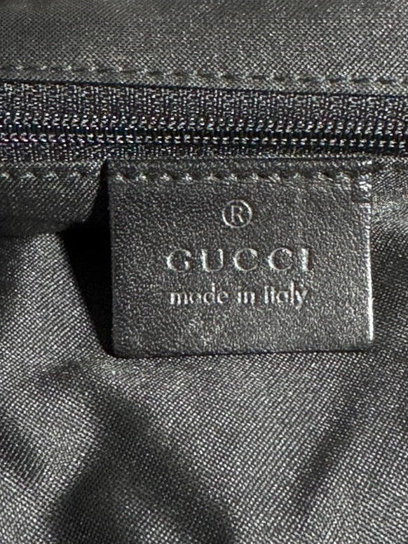 Gucci logo on a black fabric surface