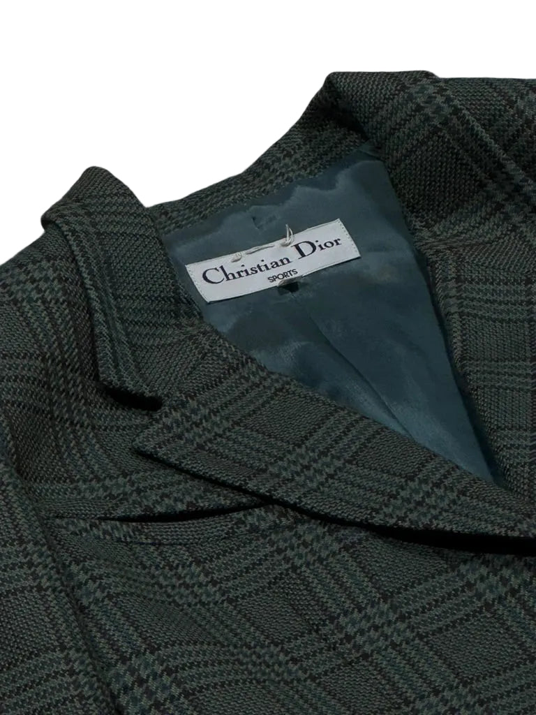 Dark green textured fabric with a Christian Dior label on a gray background