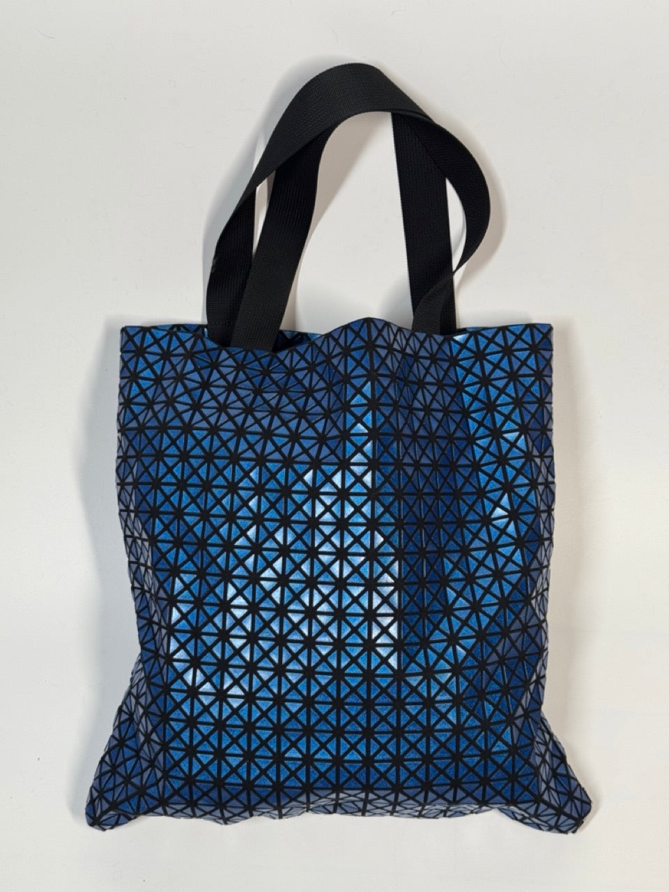 Blue geometric patterned tote bag on a white background
