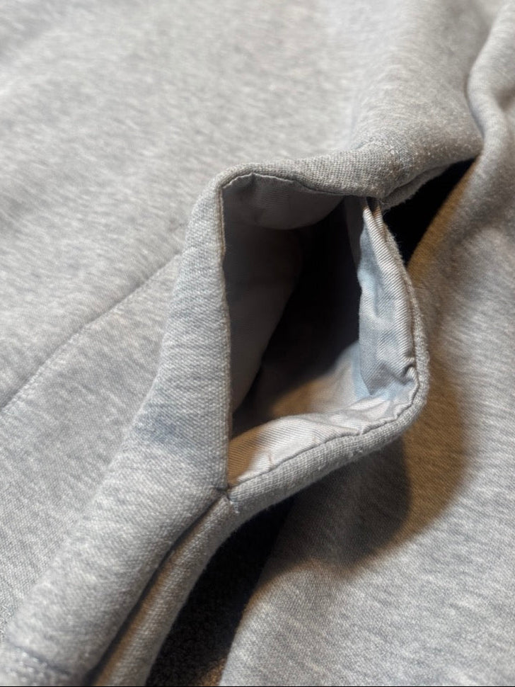 Close-up of a gray hoodie with a focus on the fabric texture.