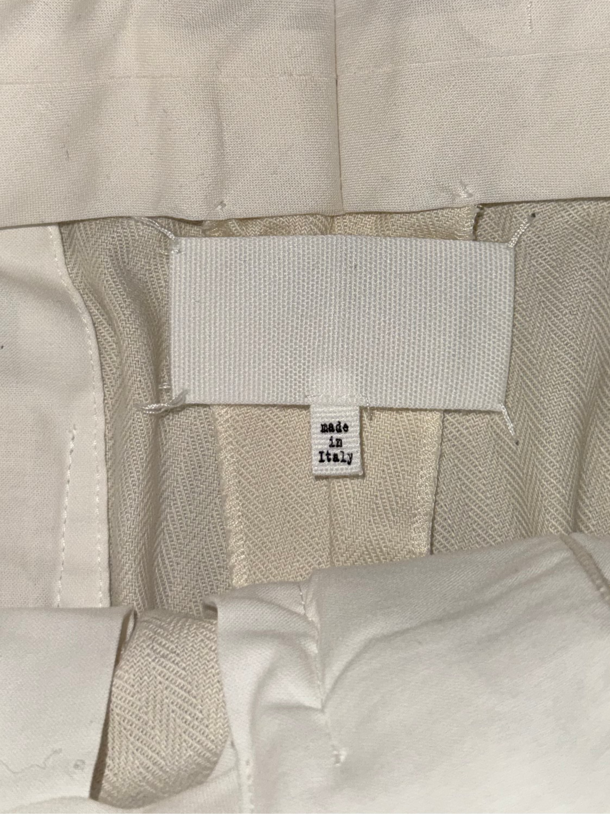 Close-up of beige fabric with a label on a dark background