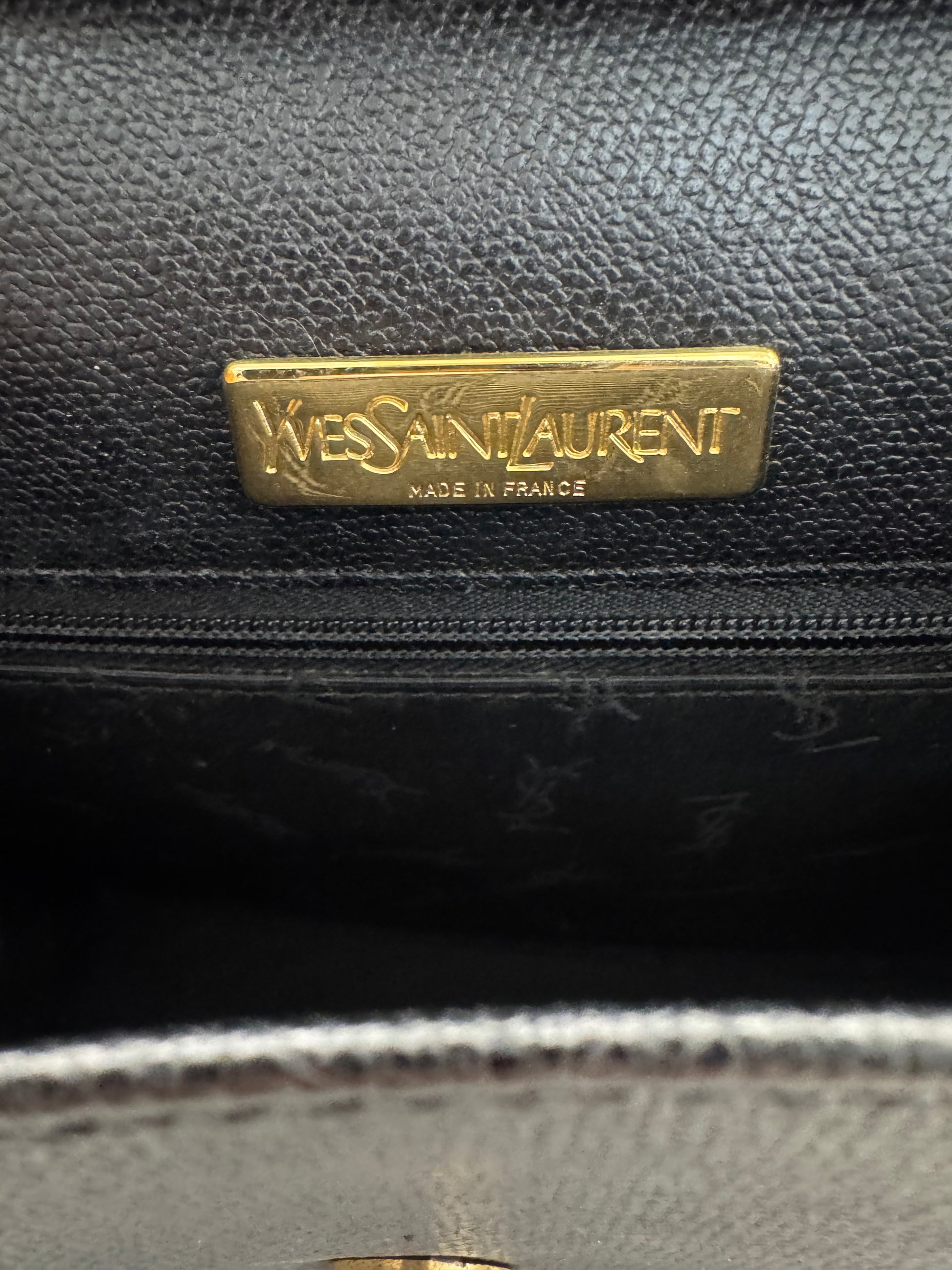 Black leather handbag with Yves Saint Laurent logo