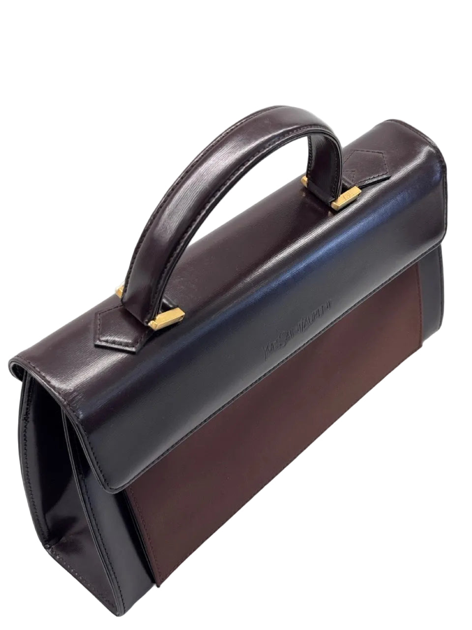 Brown leather handbag with gold accents on a light gray background