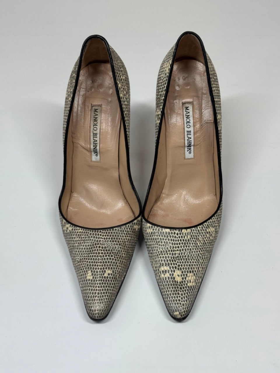 Pair of Manolo Blahnik shoes with a patterned toe cap on a white background