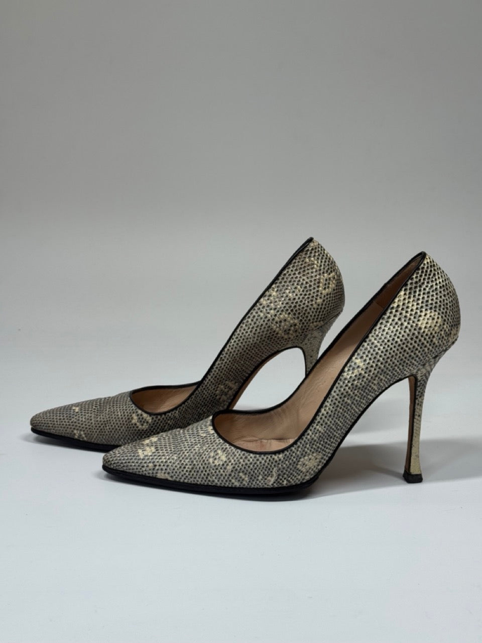 Pair of Manolo Blahnik shoes with a patterned toe cap on a white background