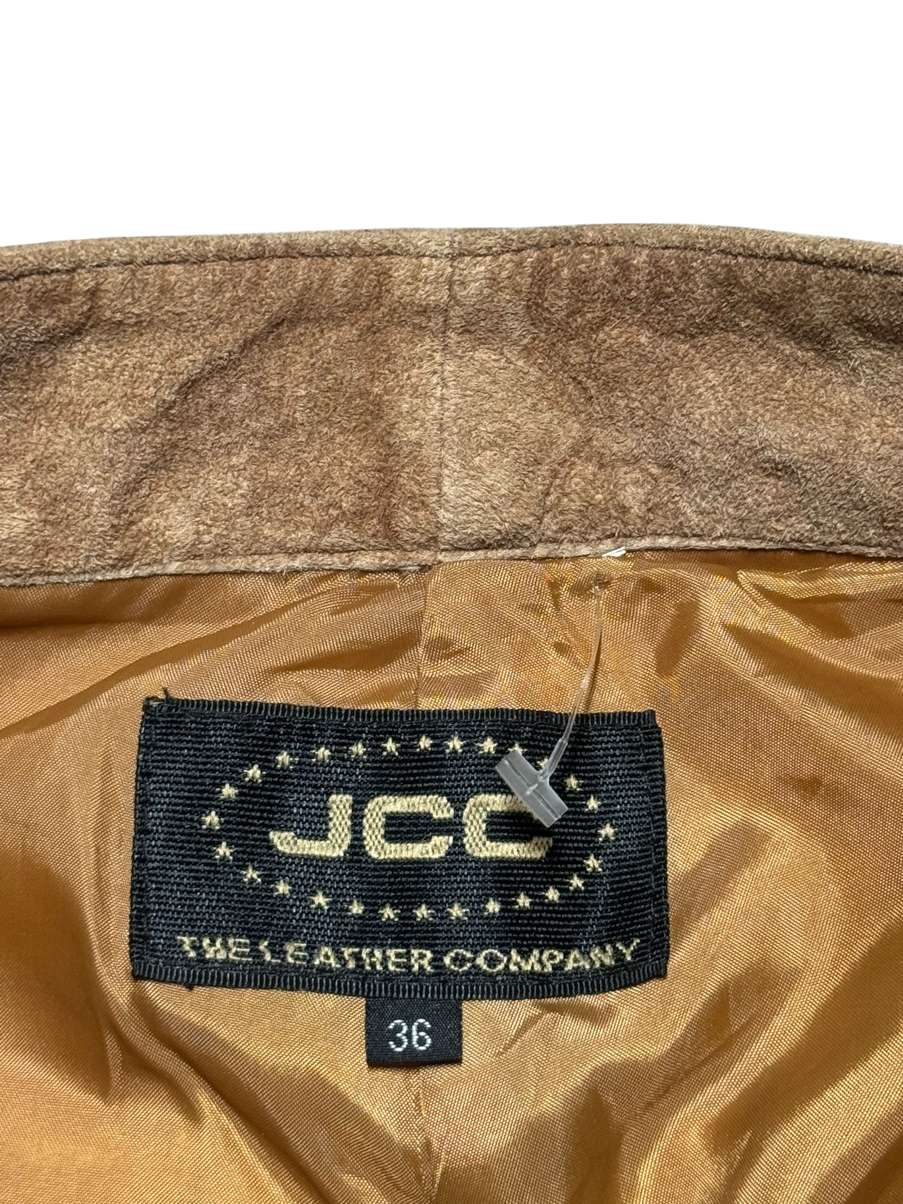 Close-up of a brown leather jacket with a JCC label on a white background