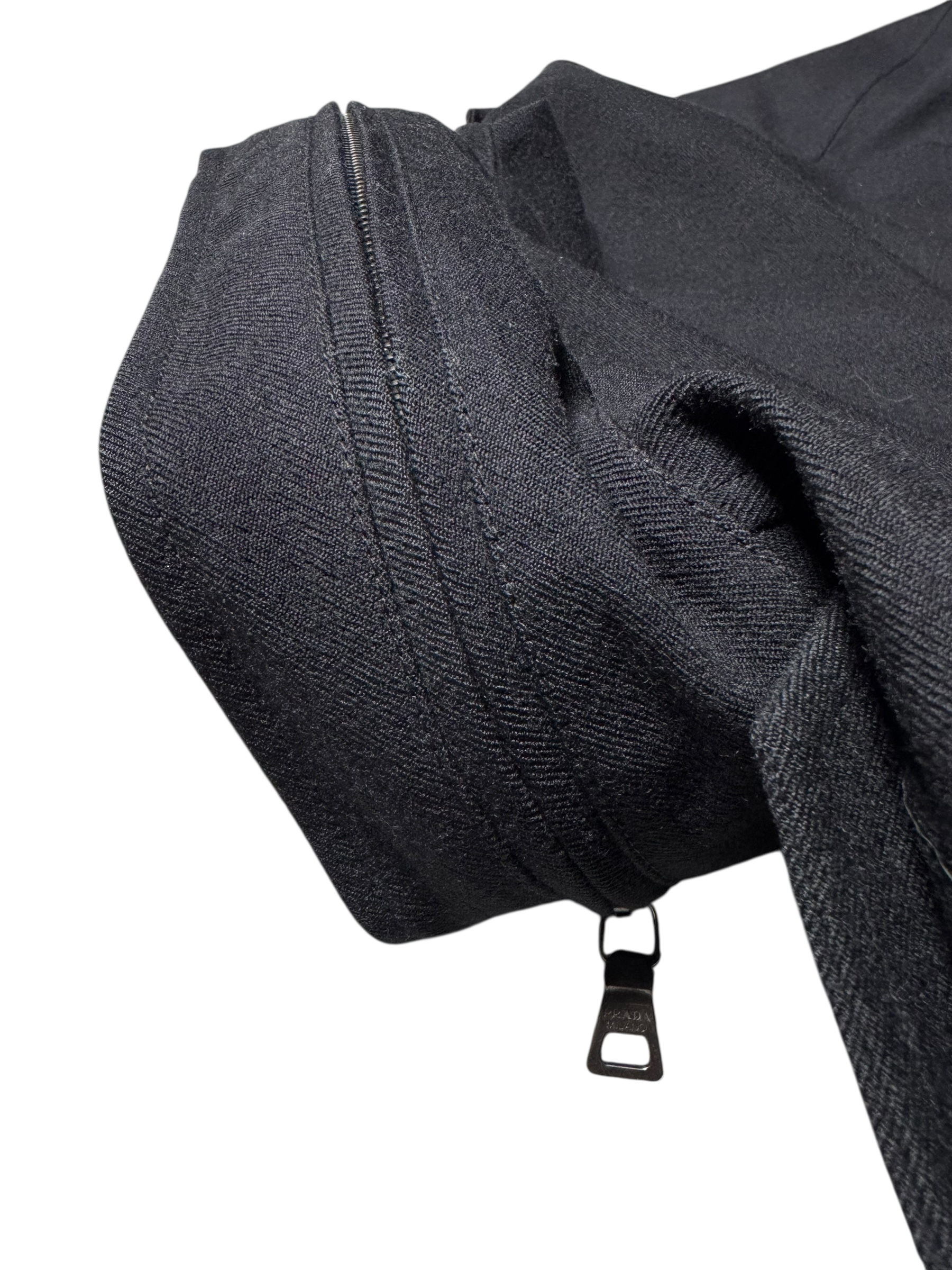 Close-up of a black zipper on a garment with a white background