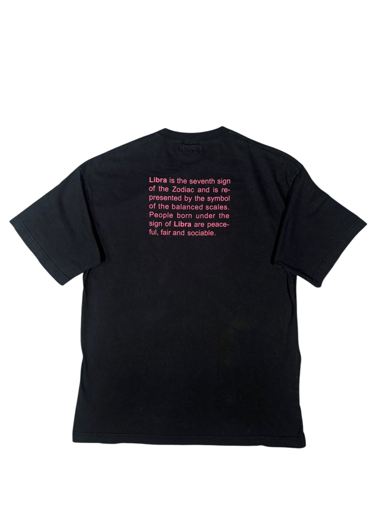 Black vintage "Vetements" t-shirt with a small pink logo on a white background
