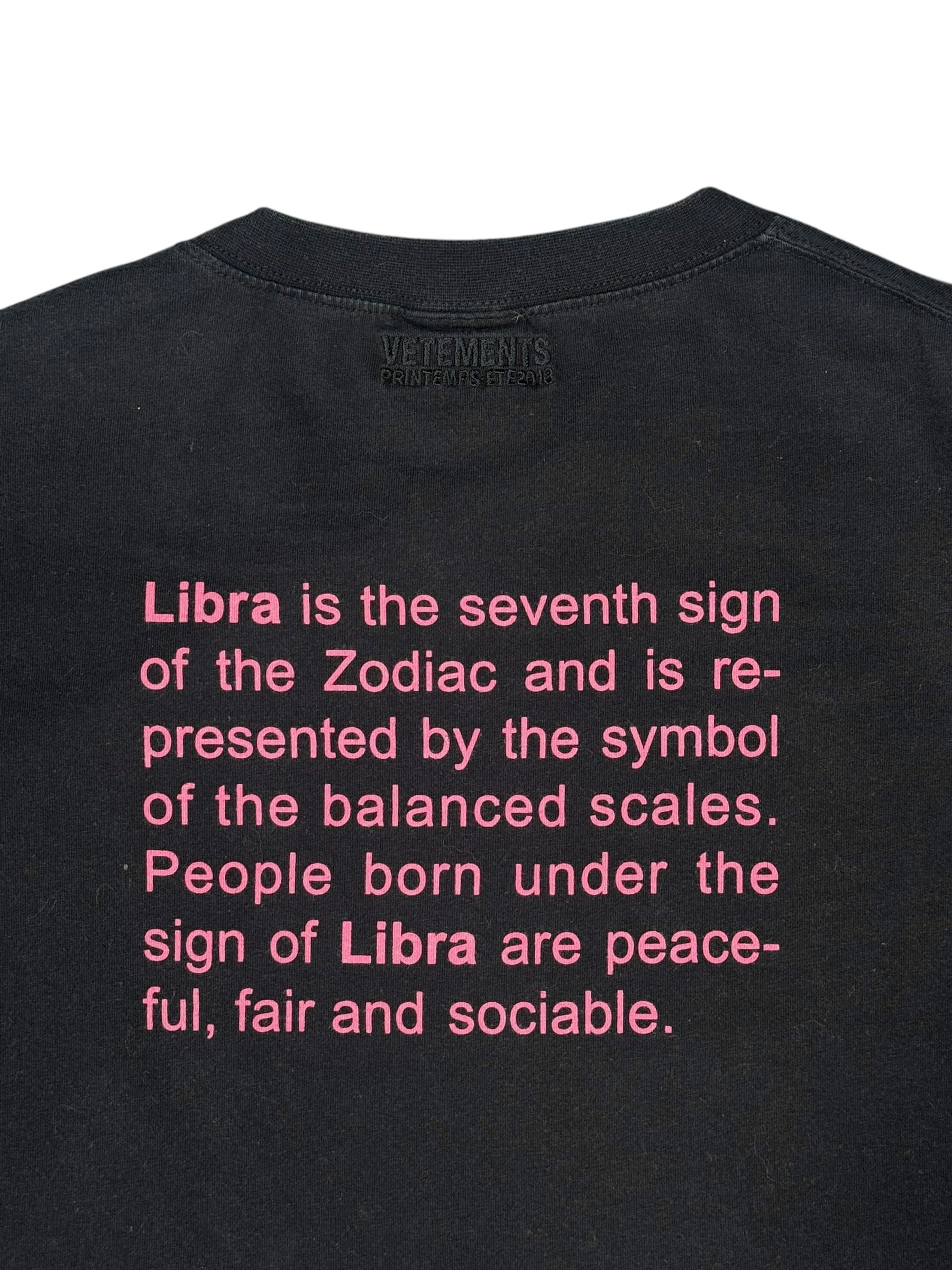 Black t-shirt with pink text about Libra on a white background