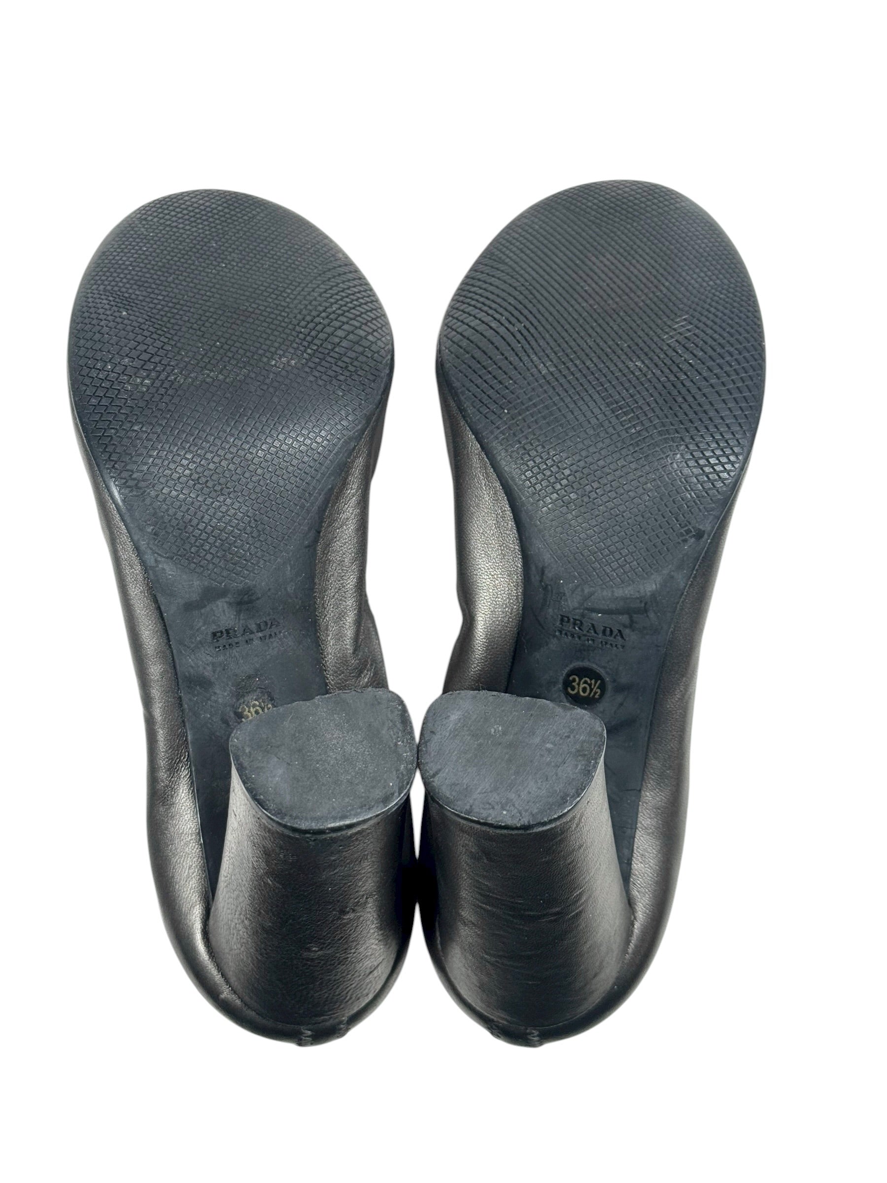 Black shoe insoles on a white background