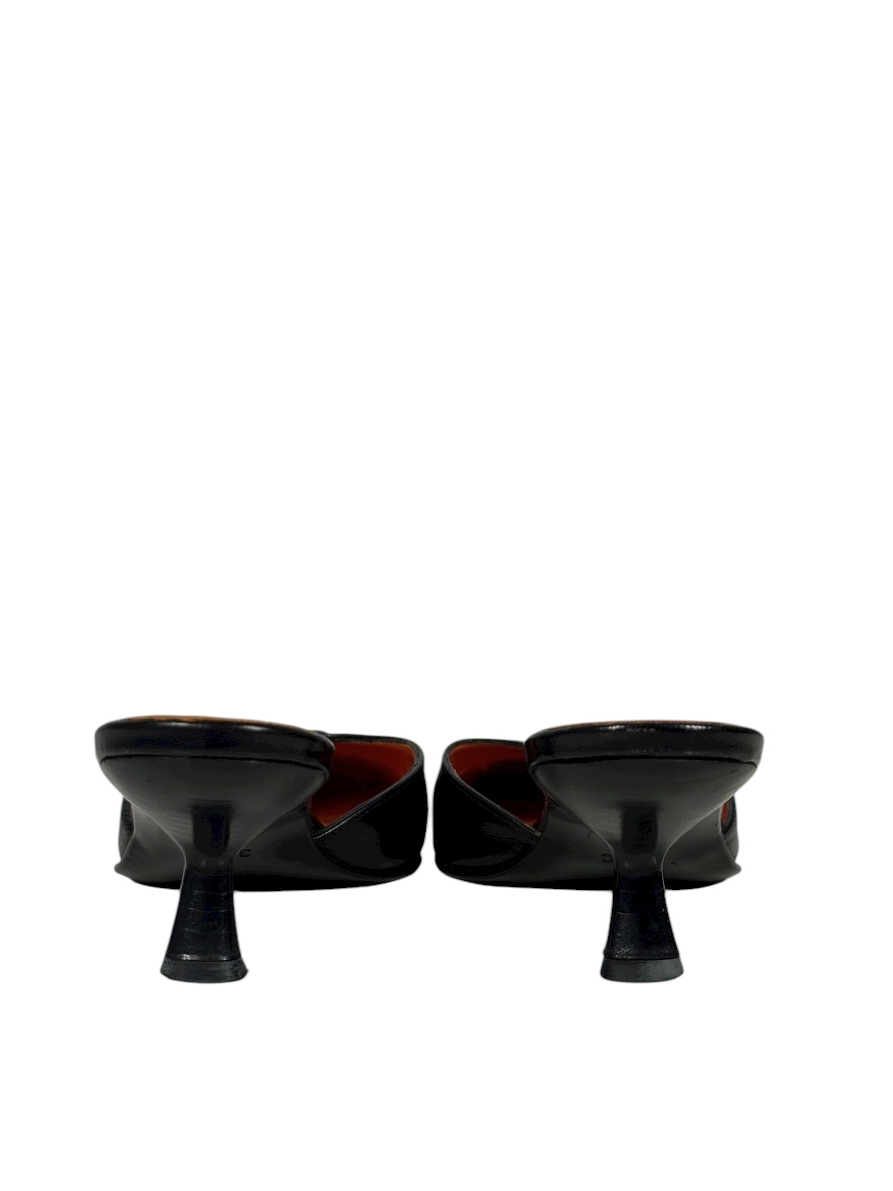 Two black ceramic bowls on stands against a white background