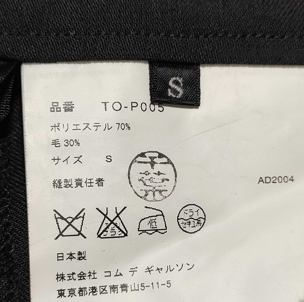 Clothing label with text and symbols on a black background