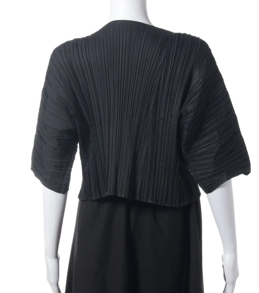 A black pleated short-sleeve wrap-style top displayed on a white mannequin against a plain white background.