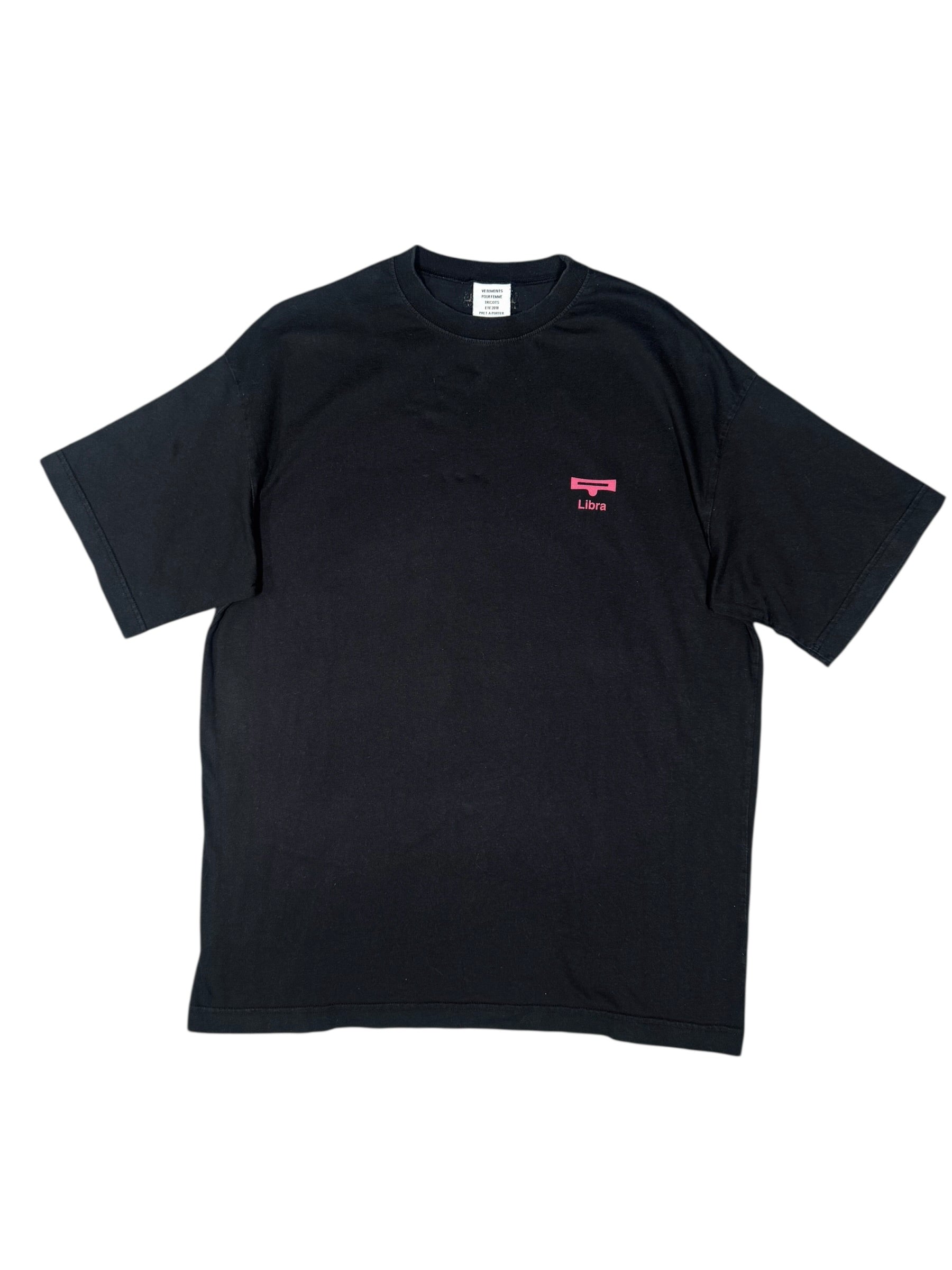 Black vintage "Vetements" t-shirt with a small pink logo on a white background